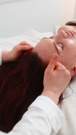 woman experiences scalp massage in cosmetology beautician performs soothing therapeutic procedure