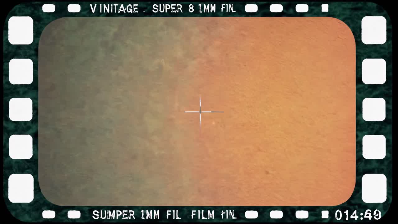 Vintage video frame with a retro film border, center crosshair, and sepia tone
