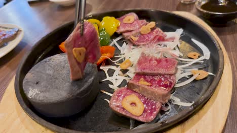 sizzling beef slices on a hot stone