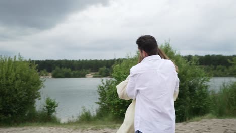 husband running after his beautiful wife in her yellow dress. (slow motion)