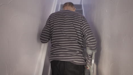 Man using crutches on stairs