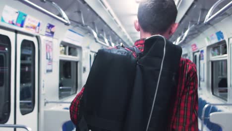 man walking through subway car