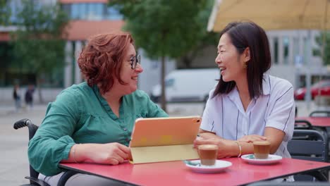 two women at a cafe having coffee