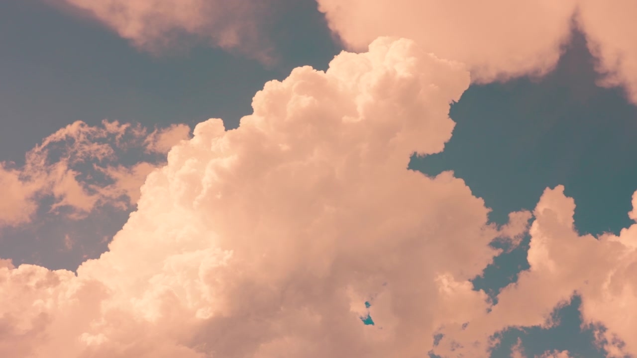 Large White Cumulus Clouds Drifting Across a Blue Sky