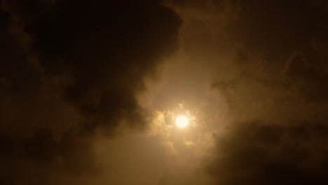 sun shining through dark clouds