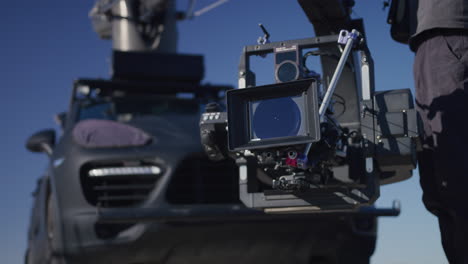 Cinema-camera-on-a-crane-in-front-of-car-in-Las-Vegas,-Nevada