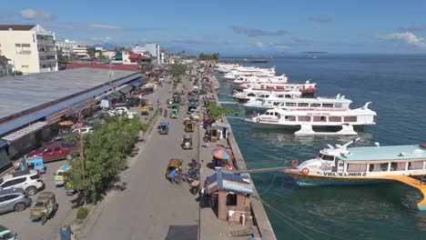 Passenger-vessels-moored-at-the-seaport-while-loading-cargo,-aerial-dolly-in