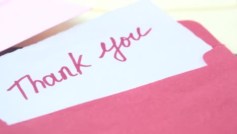 thank you note in pink envelope