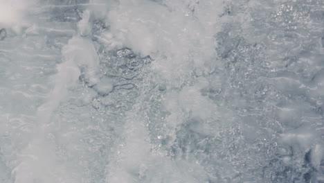 fast stream water. frozen waterfall. icy waterfall close-up. falling water.