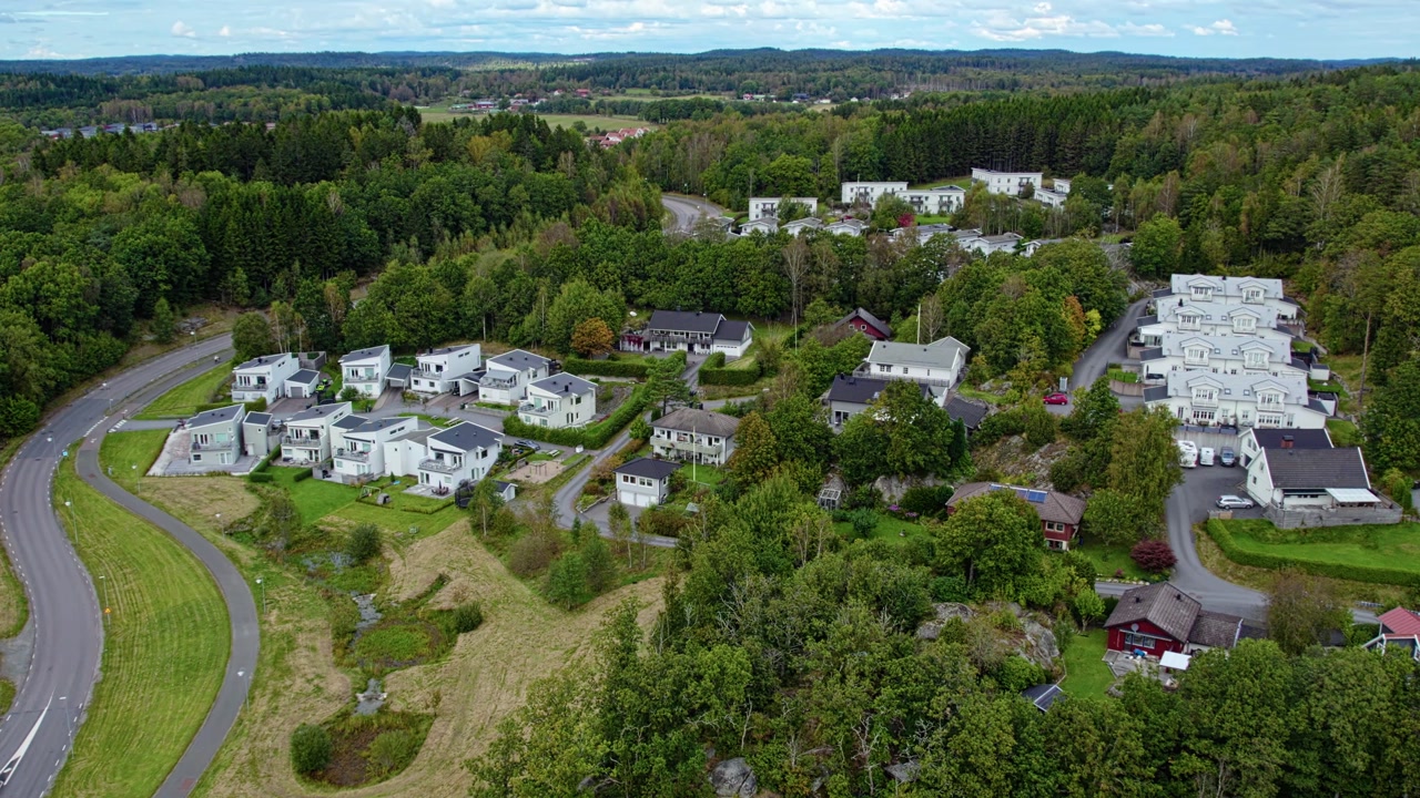 Aerial drone view shows modern villas in Kungalv with detached houses curved roads green trees open land and organized housing layout in quiet suburban landscape
Kungälv, Sweden