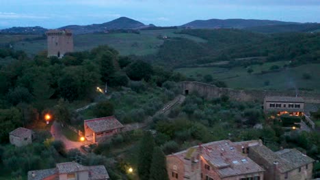 evening  in san quirico d'orcia, tuscany, italy. aerial view of houses, tower and italian landscape