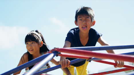 schoolkids playing on dome climber in playground