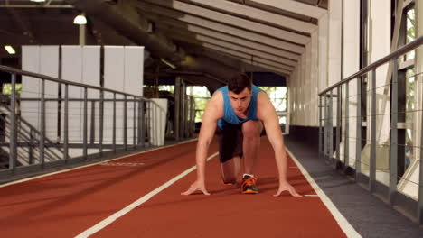 young man ready to race on running track