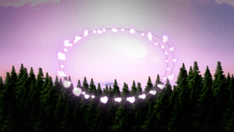 animation of fairy light frame with copy space over fir trees and winter scenery