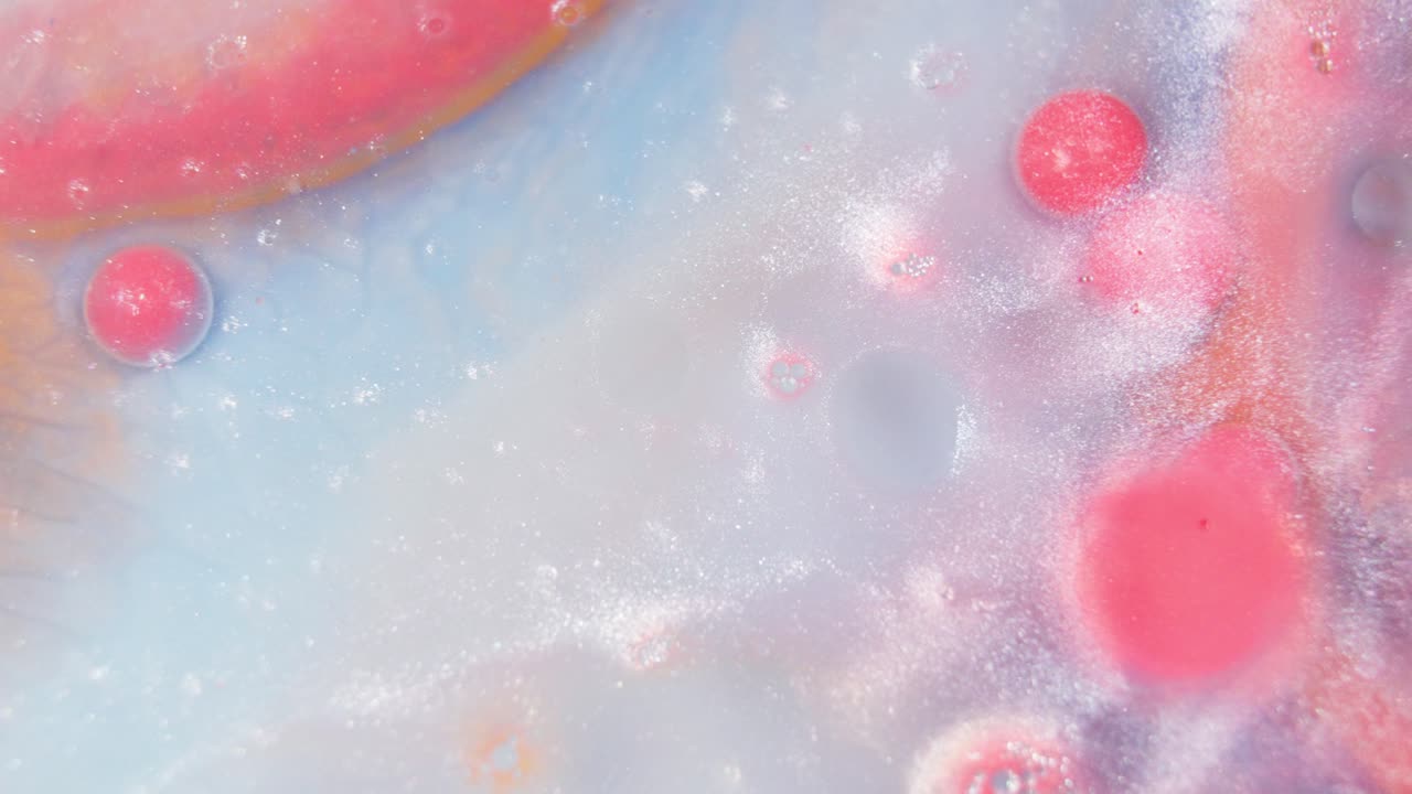 Flowing red ink in white watercolor liquid creating abstract art