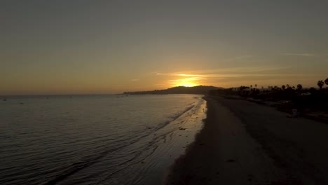 Drone-Volando-Sobre-El-Océano-De-Santa-Bárbara-Viendo-La-Vibrante-Puesta-De-Sol