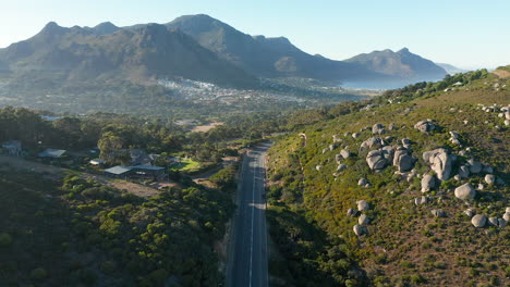 scenic highway in llandudno at sunrise with hout bay in the background in western cape, south africa