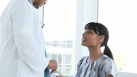 Positive-doctor-examining-his-patients-throat