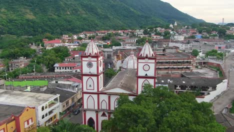 beautiful white and brown cathedral in central america city by mountains