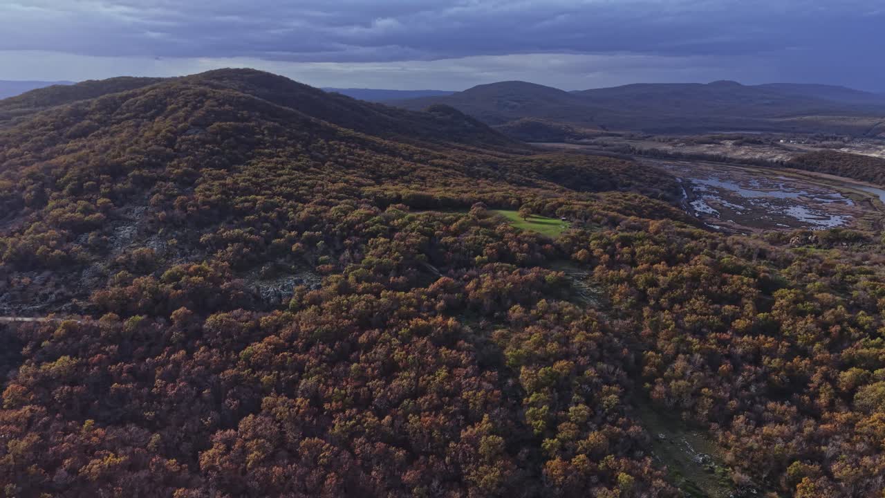 Vast landscape of rolling hills and autumn foliage in aerial view