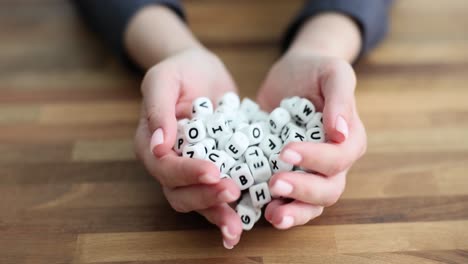a pile of letter dice scattered on a wooden table