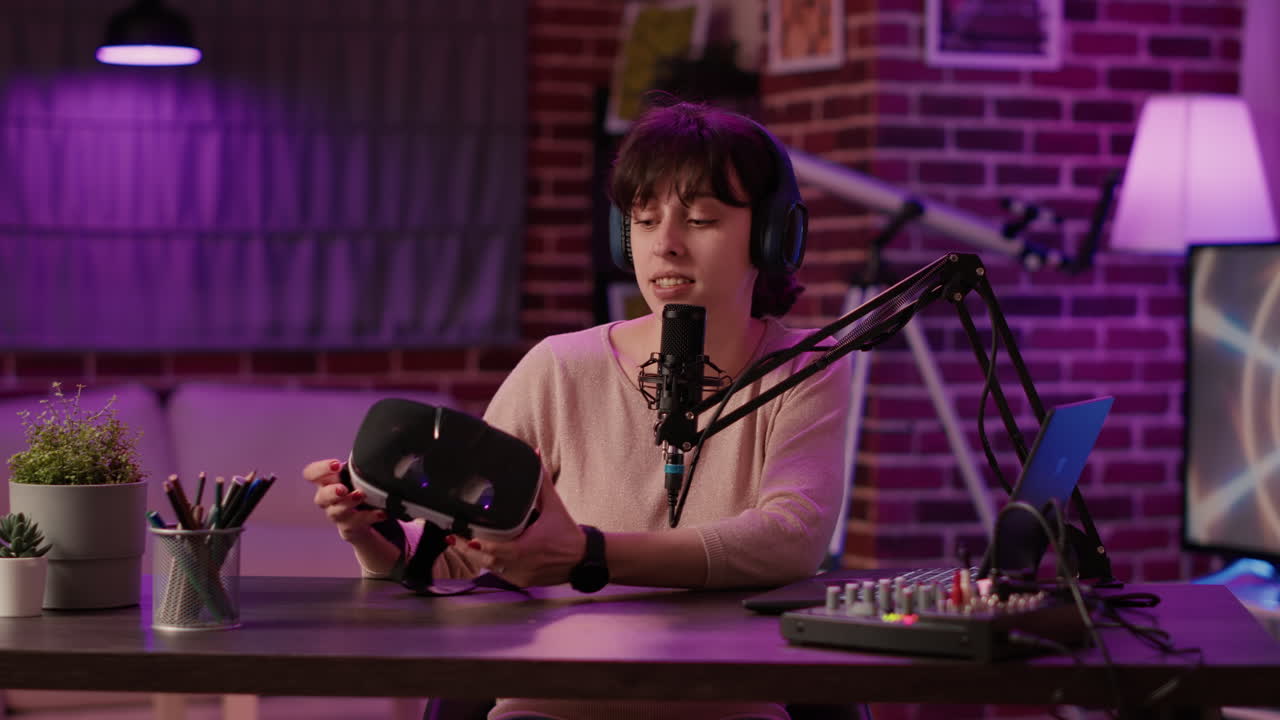 Woman vlogger influencer recording product review for virtual reality goggles with professional audio equipment