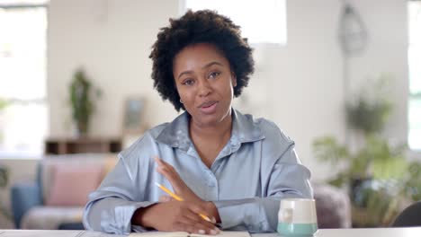 happy african american casual businesswoman making video call in office, slow motion