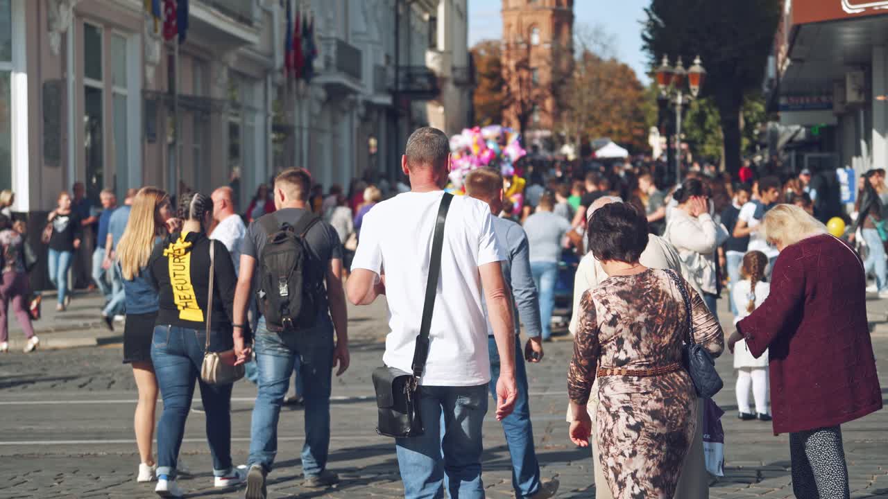 Walking people in the street. Crowd of anonymous people walking on busy city street