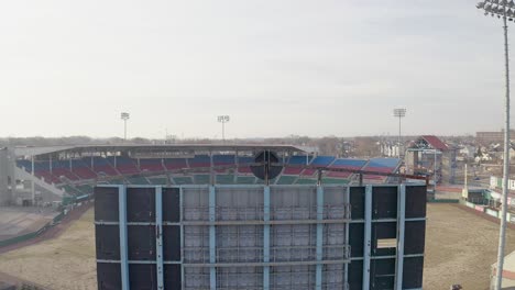 mccoy stadium in pawtucket rhode island, drone rising over scoreboard to reveal the abandoned baseball field, aerial