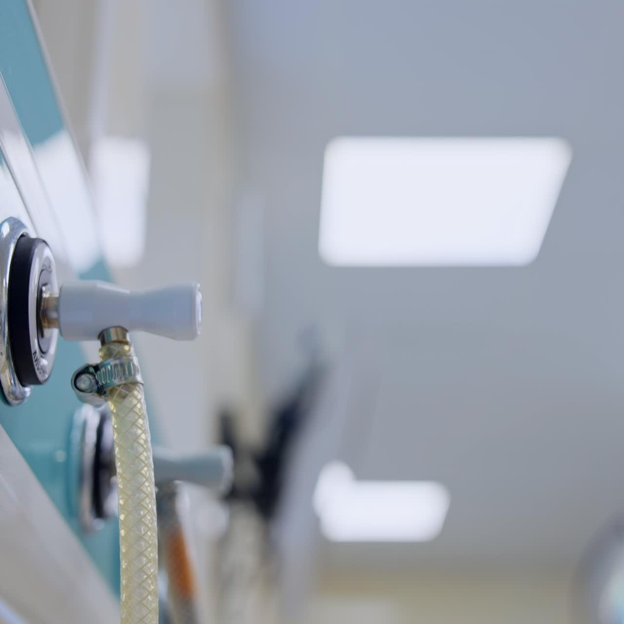 Connected tubes of equipment for oxygen supply in surgical room. Close up. Low angle perspective. Blurred backdrop