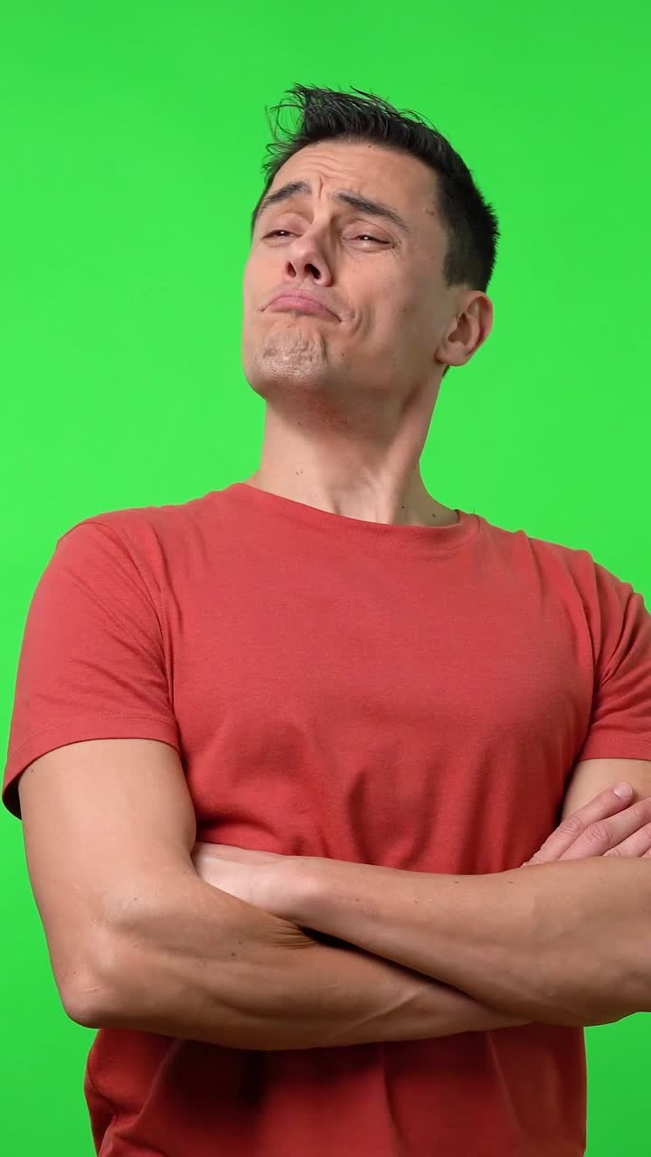 Man in red shirt posing against green screen