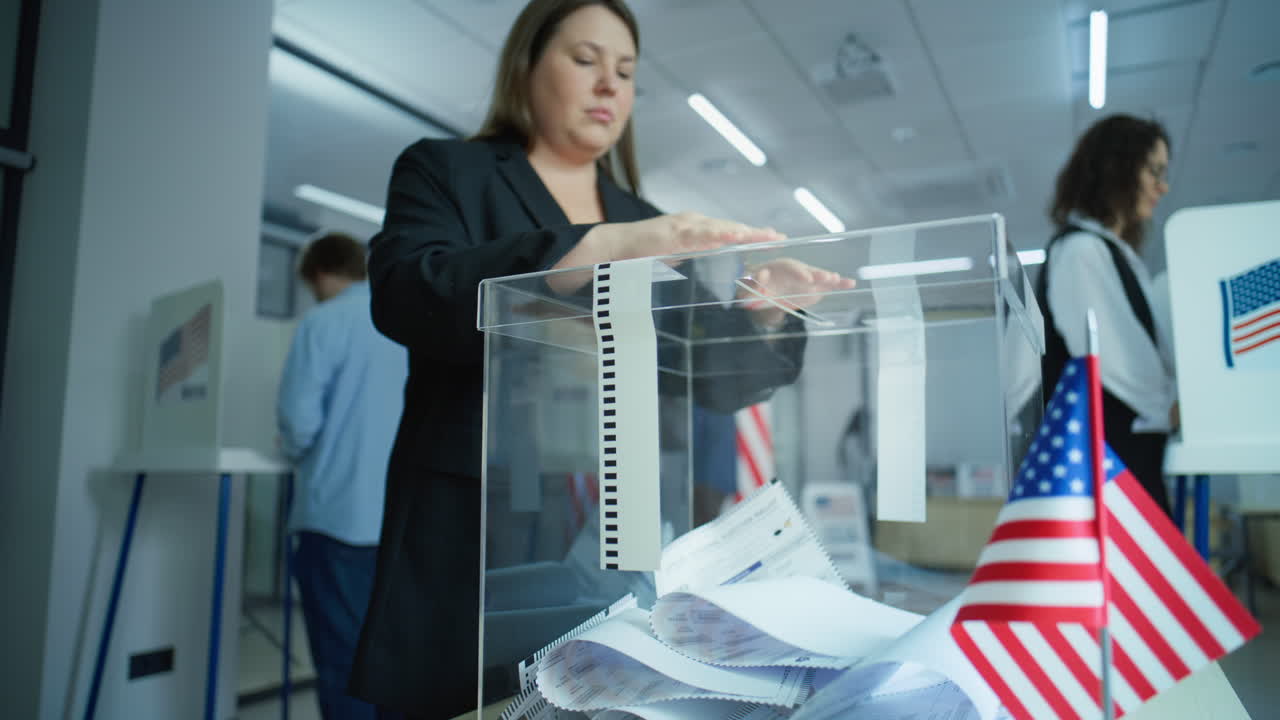 Caucasian Woman Puts Voting Ballot in Box during Elections Diverse Voters American People Vote for Future President in Voting Booths at Polling Station Caucasian Woman Puts Ballot in Box National Election Day in the United States of America Slow Motion