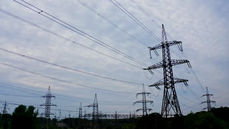 silhouette of electric towers in the evening. high-voltage electric lines under the beautiful sky. transmission lines. many electrical pylons in nature.