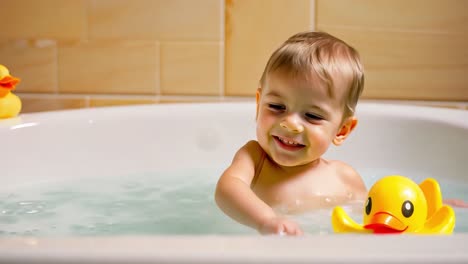 happy toddler playing in the bath