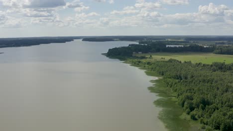 aerial view high above green marsh along coast of finland