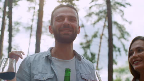 smiling friends having conversation outside. man speaking with friends outdoors