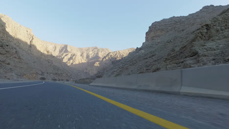 Shot-of-mountain-range-and-road-from-car