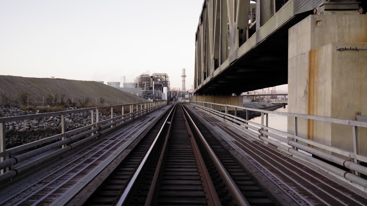 POV train crosses a railway bridge. Camera slowly moves forward