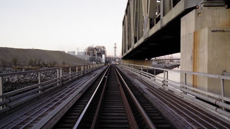pov train crosses a railway bridge. camera slowly moves forward