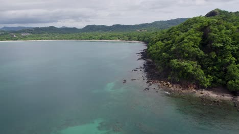 A-4K-drone-shot-of-Punta-Sabana-Point-and-the-Mirador-Conchal-Peninsula-next-to-Puerto-Viejo-and-Playa-Conchal,-or-“Shell-Beach”,-along-the-north-western-coast-of-Costa-Rica