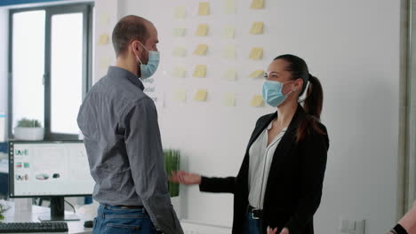 Coworkers-with-face-mask-touching-elbow-with-his-collegue