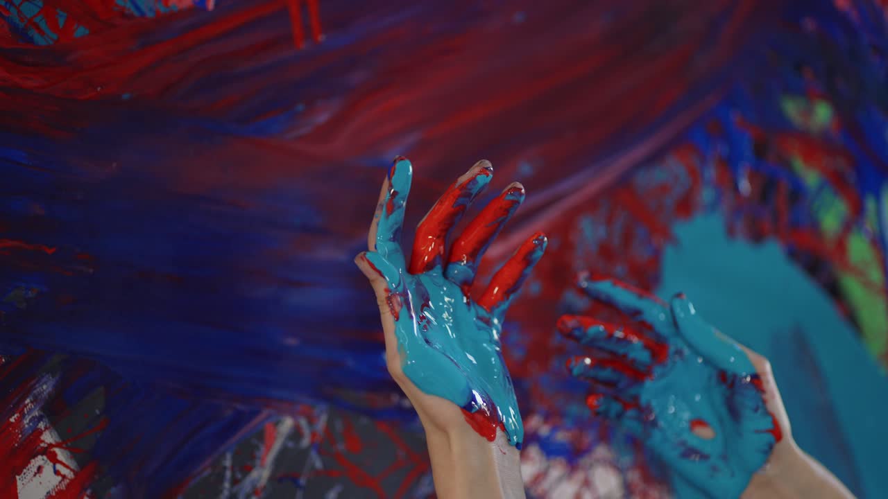 Artist's hands in paints, woman paints on canvas, Close Up