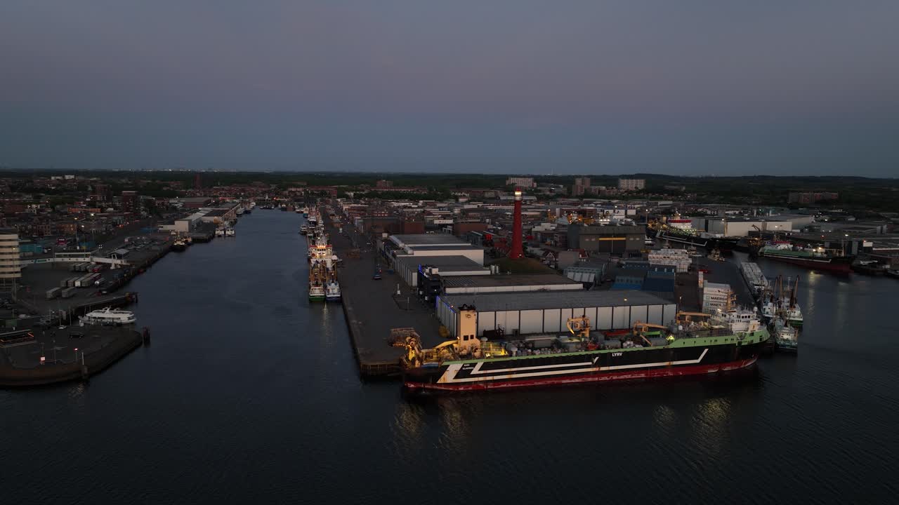 port of Ijmuiden, sunset, lighthouse, industrial port, North sea canal, aerial drone view.