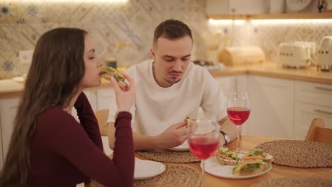 loving couple making a sandwich in kitchen-living room