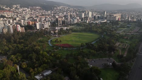 Aerial-drone-video-view-footage-of-Qutio-early-morning-sunrise-capital-city-of-Ecuador-La-Carolina-Park-traffic-Catedral-Metropolitana-de-Quito-south-american-skyline