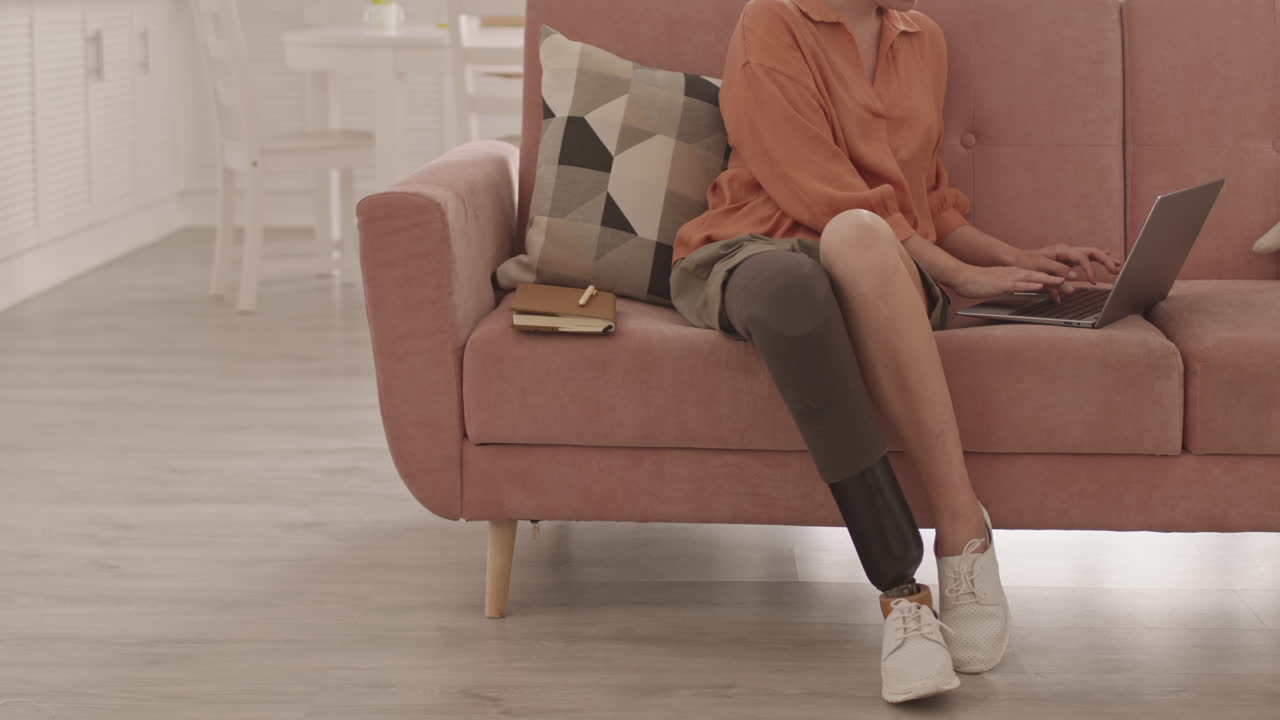 Woman with Artificial Leg Working at Home