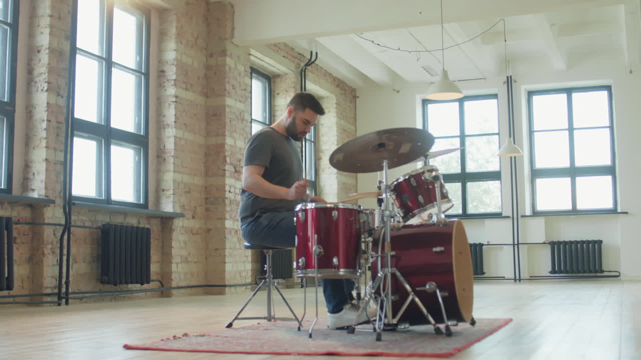 Man Walking to Drum Kit and Playing Music