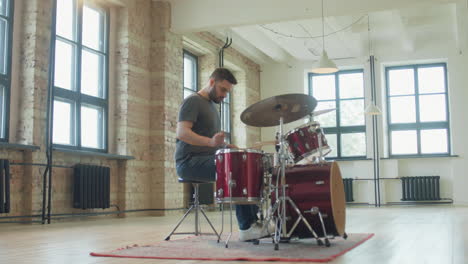 Man Walking to Drum Kit and Playing Music
