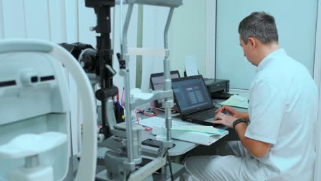 male doctor in office working at computer