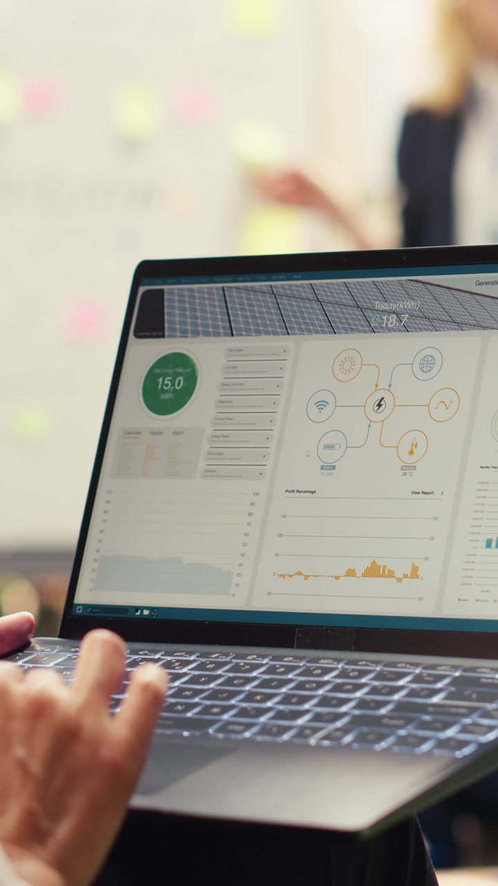 Vertical Video Business employee reviewing solar energy dashboard for sustainability